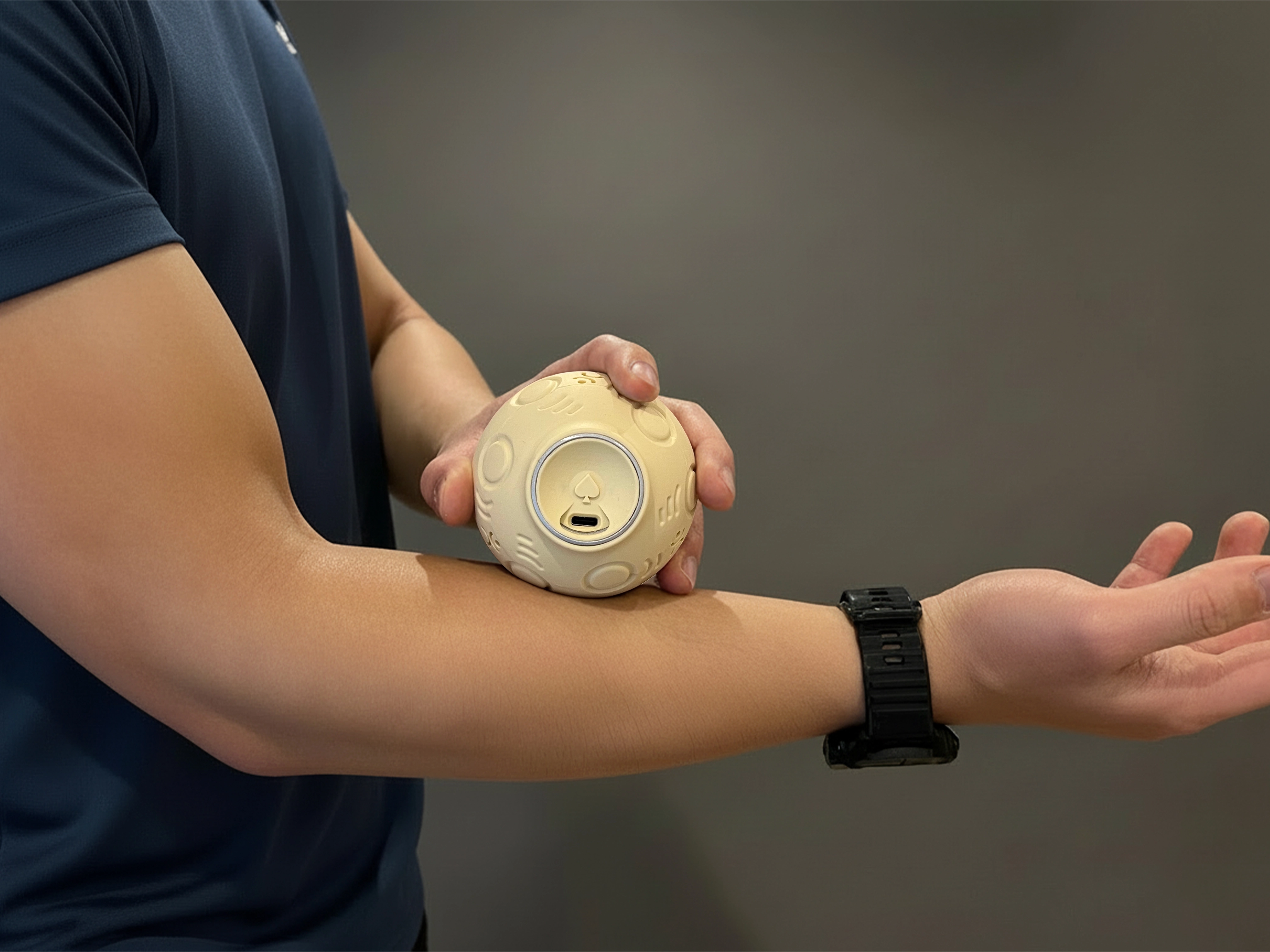 Hand holding OMGO on forearm